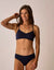Navy blue bikini bottom with fold-over waistband, worn by model against neutral background