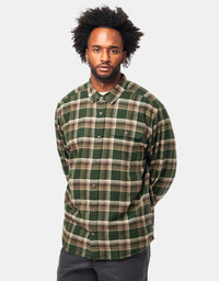 Men's long-sleeve plaid flannel shirt in green tartan pattern, front view on model