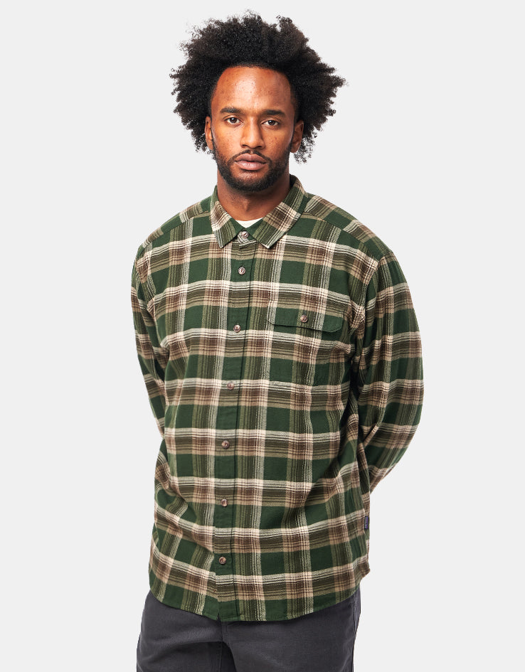 Men's long-sleeve plaid flannel shirt in green tartan pattern, front view on model