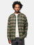 Men's long-sleeve plaid flannel shirt in green tartan, worn open over white tee, front view