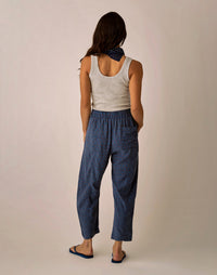 Navy blue linen pants with small dot pattern, back view showing relaxed fit and ankle length
