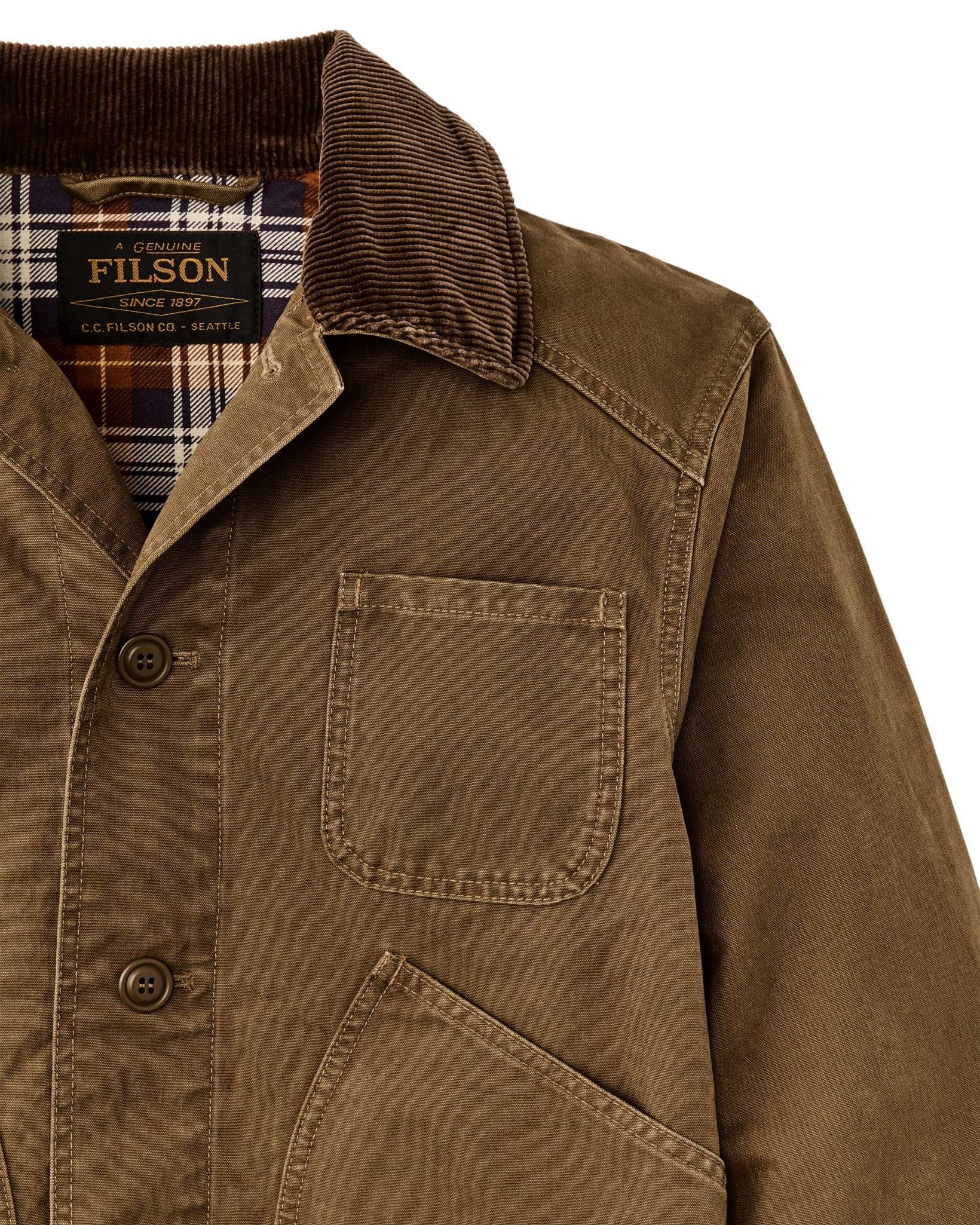Close-up detail of waxed canvas jacket with corduroy collar, chest pocket, and plaid lining