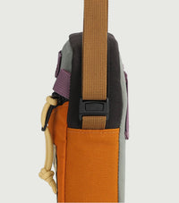 Multi-colored mini shoulder bag side profile showing colorblock panels and adjustable straps
