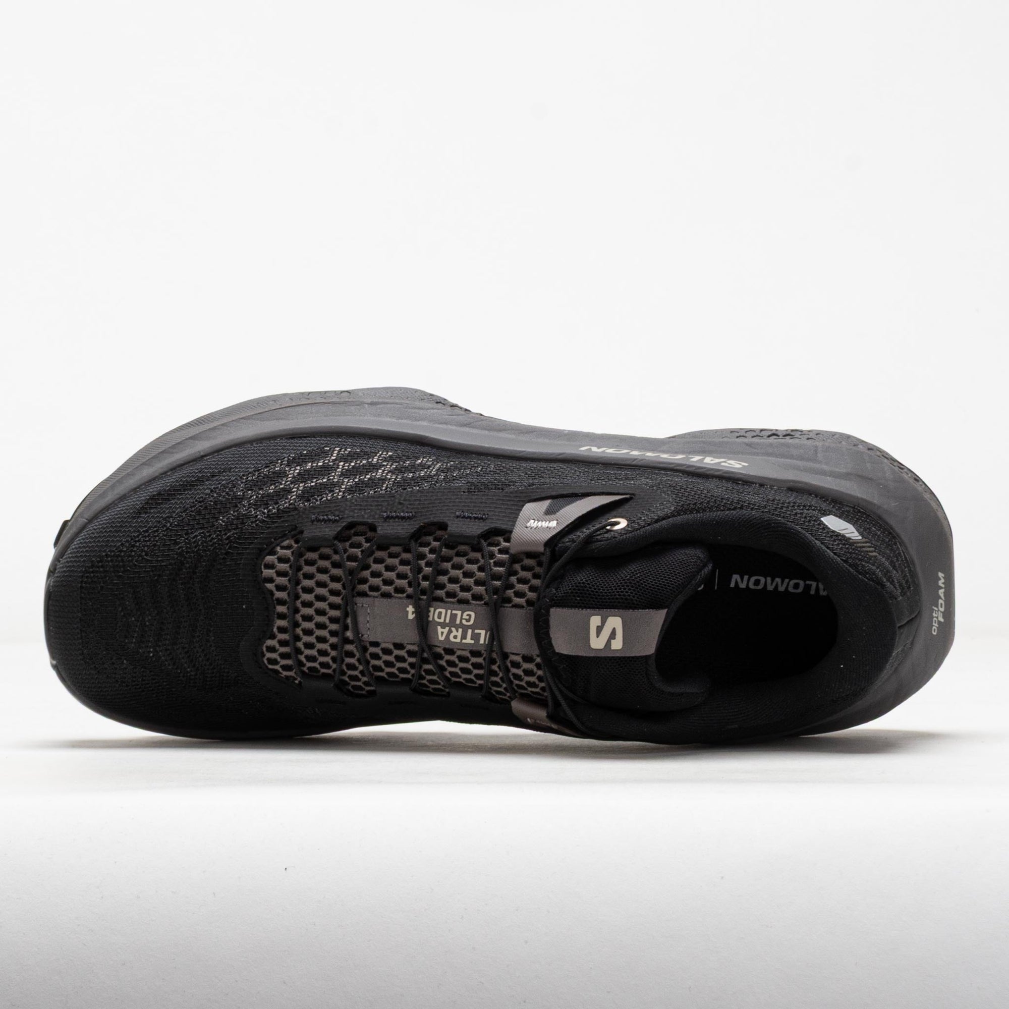 Top-down view of black trail running shoe with hexagonal mesh upper and thick sole