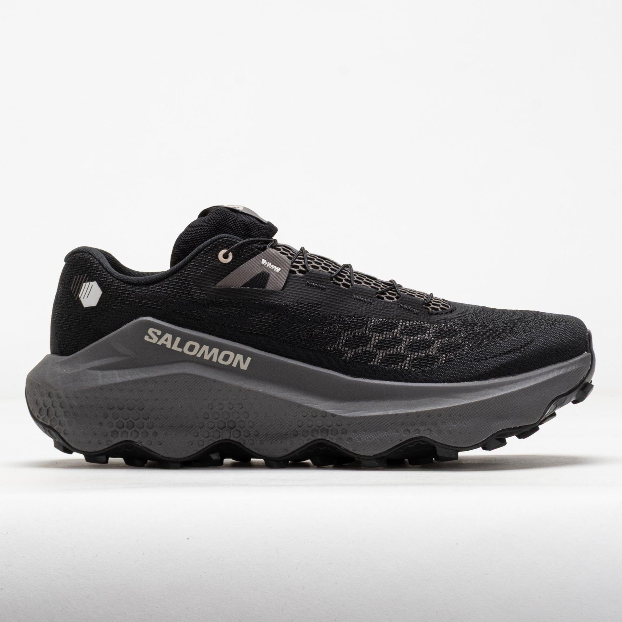 Black trail running shoe with chunky gray midsole and aggressive lug outsole, lateral view