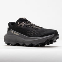 Black trail running shoe with chunky gray midsole and aggressive lug outsole, side view