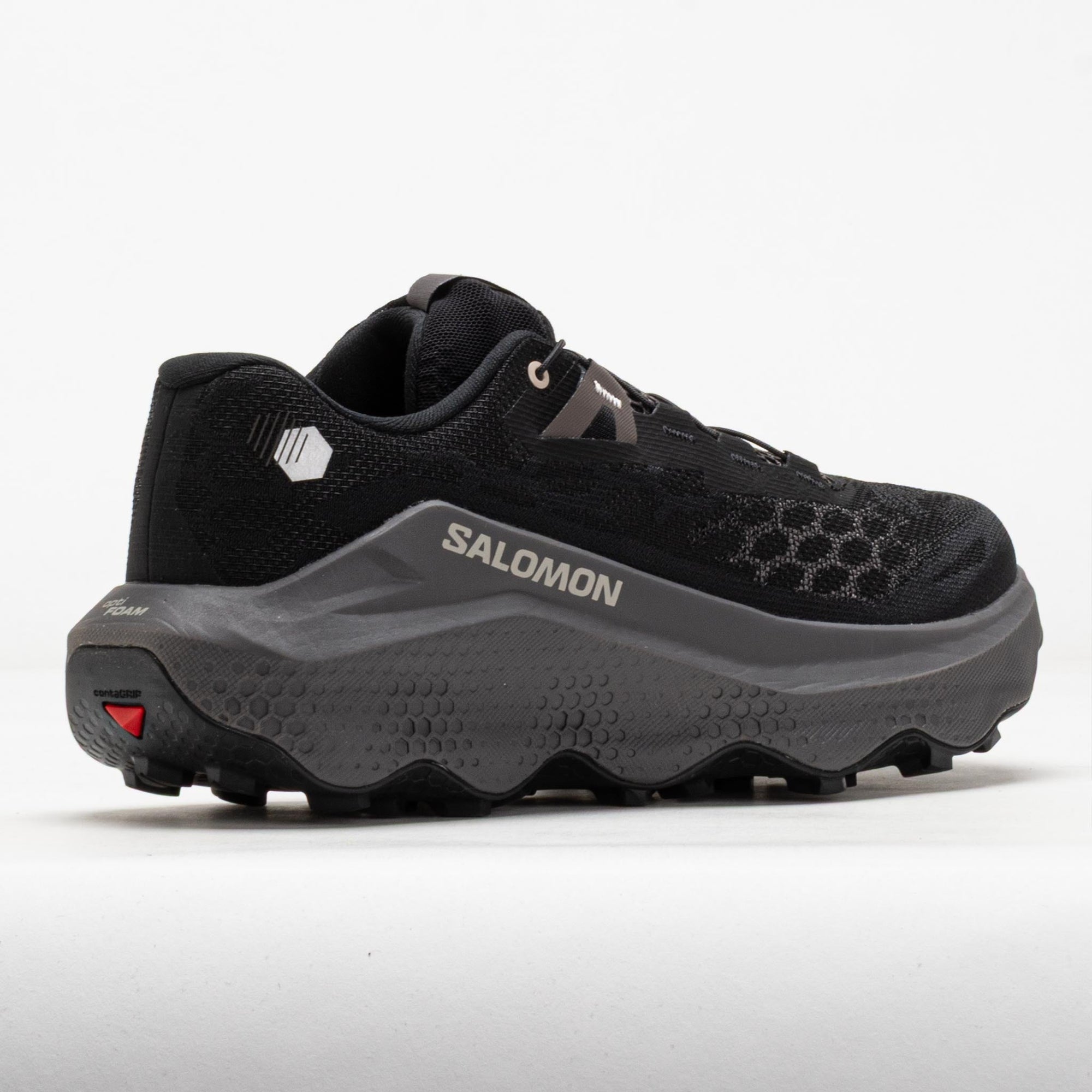 Trail running shoe rear three-quarter view showing aggressive lugged outsole and mesh upper