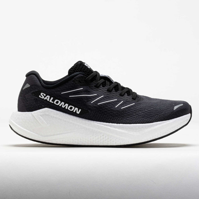 Dark gray running shoe with white midsole, side profile view showing mesh upper and laces