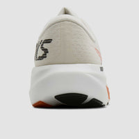 Running shoe rear view showing white knit upper, thick white midsole, and orange-black outsole