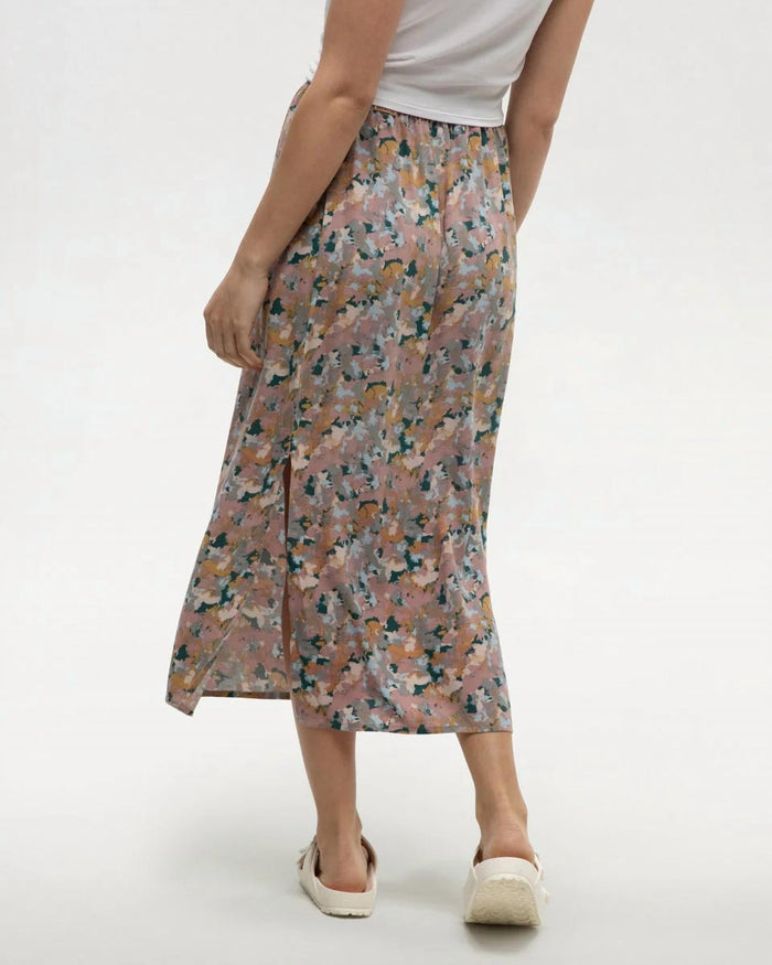 Midi-length floral skirt with side slit, back view on model with white top and espadrilles