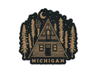 Circular sticker featuring A-frame cabin in forest with moon and stars on black background