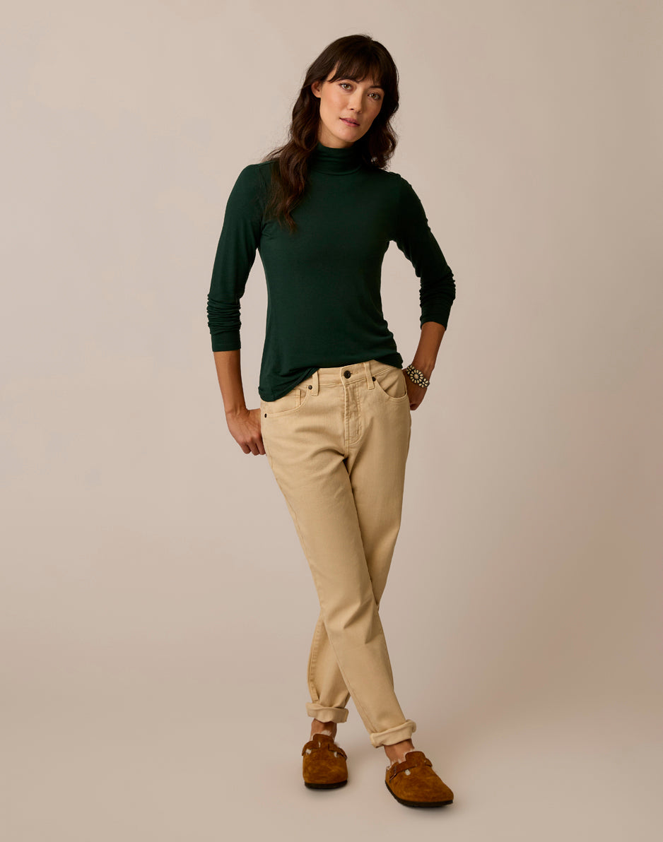 Women's long-sleeve turtleneck in dark green, fitted silhouette, full front on-model view