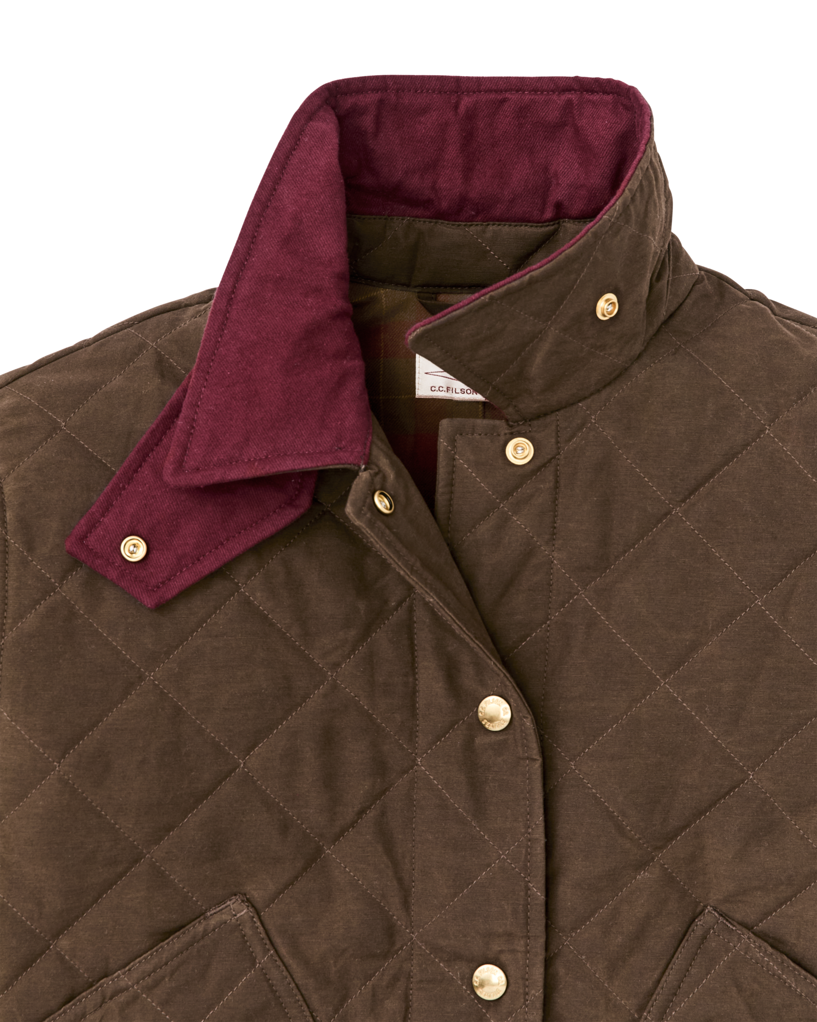 Quilted women's jacket close-up showing diamond stitching, snap buttons, and burgundy collar lining