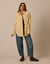 Oversized cream button-up shacket with chest pockets, worn open over navy top with wide-leg jeans