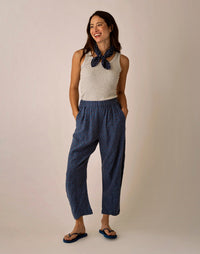 Wide-leg cropped pants in navy with small dot print, elastic waistband, styled with tank top