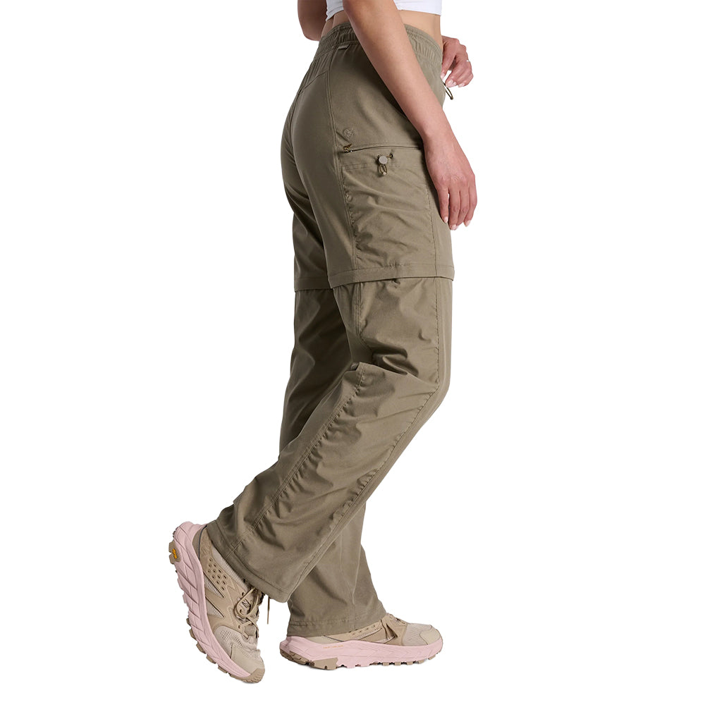 Olive green convertible zip-off pants with cargo pockets, side profile view on model