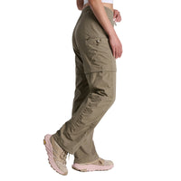 Olive green convertible zip-off pants with cargo pockets, side profile view on model