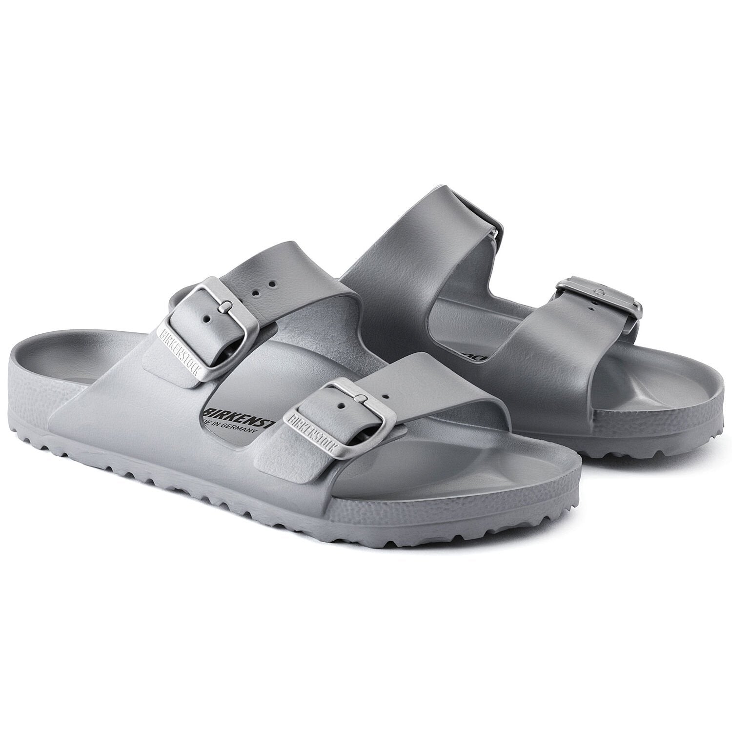 Pair of metallic silver two-strap sandals with buckles and textured sole