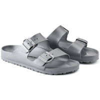 Pair of metallic silver two-strap sandals with buckles and textured sole