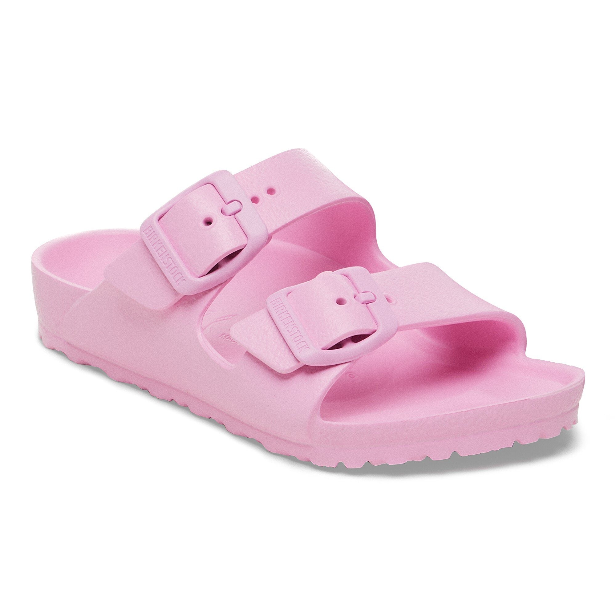 Pink two-strap sandals with adjustable buckles and textured footbed, angled view