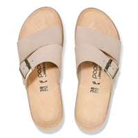 Light beige leather sandals with wide crossover straps and adjustable ankle buckles, top view