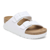 White platform sandals with two adjustable buckle straps and cork footbed, angled view