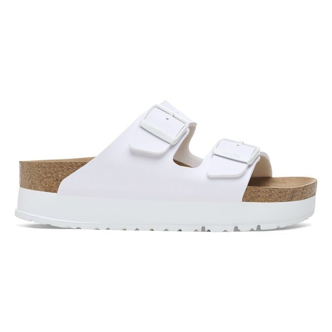 White platform sandals with two adjustable straps and cork footbed, side view