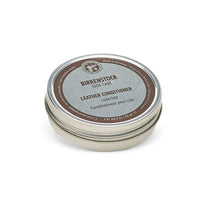 Round metal tin of leather conditioner with brown and silver label, top view