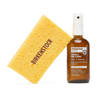 Shoe cleaning spray bottle with pump dispenser and yellow cleaning sponge on white background