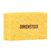 Yellow rectangular cleaning sponge with porous texture and brand logo printed on surface