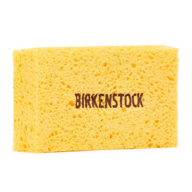 Yellow rectangular cleaning sponge with porous texture and brand logo printed on surface