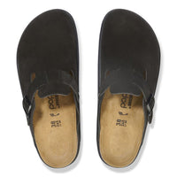Top-down view of a pair of black suede closed-toe clogs with buckle strap and cork footbed
