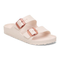 Two-strap slip-on sandals in light pink with rose gold buckles on white background