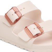 Light pink translucent dual-strap sandals with rose gold buckles on white background