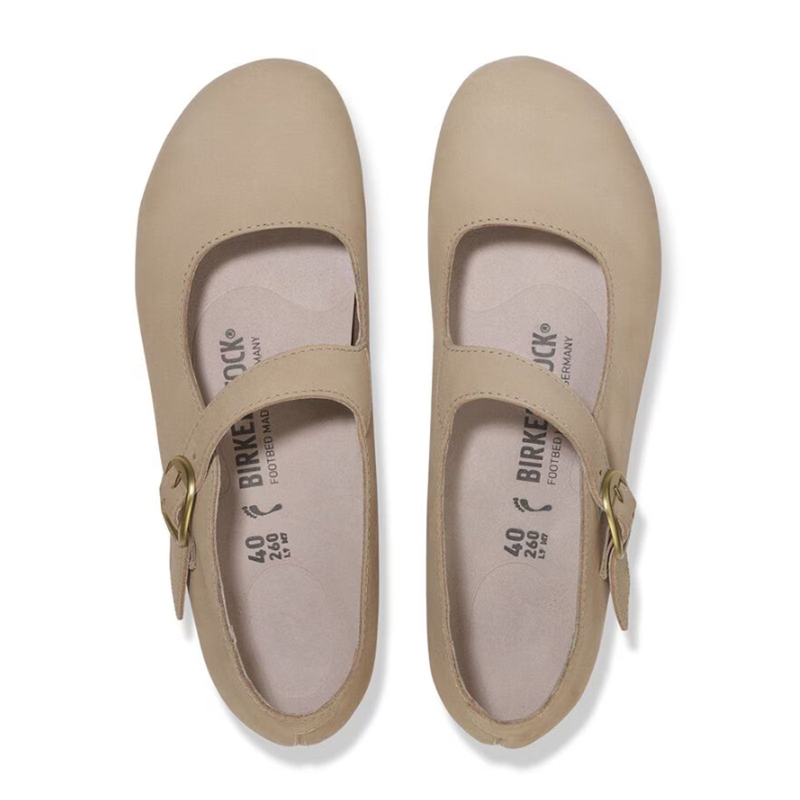 Light tan leather mary jane shoes with ankle strap and buckle closure, top view