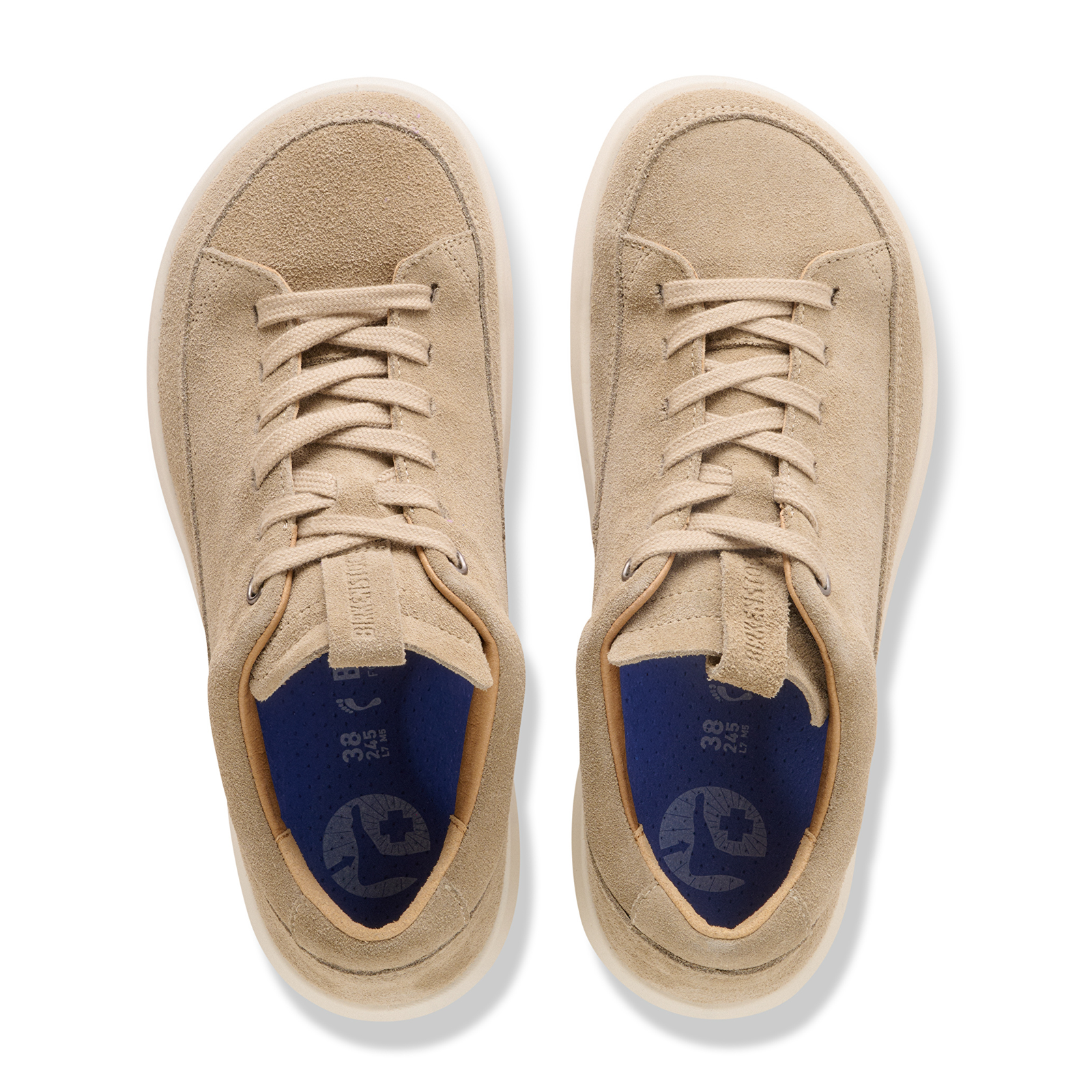 Light tan suede lace-up sneakers with white soles shown from above