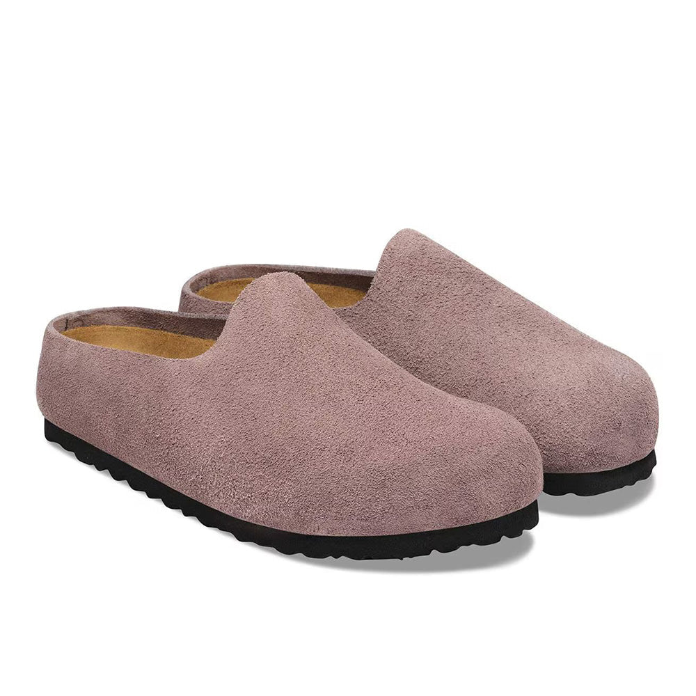 Slip-on suede clogs with closed toe, tan footbed lining, and black rubber sole, angled view