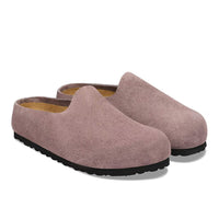 Slip-on suede clogs with closed toe, tan footbed lining, and black rubber sole, angled view