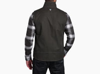 Men's canvas vest back view, worn over plaid flannel shirt with dark jeans