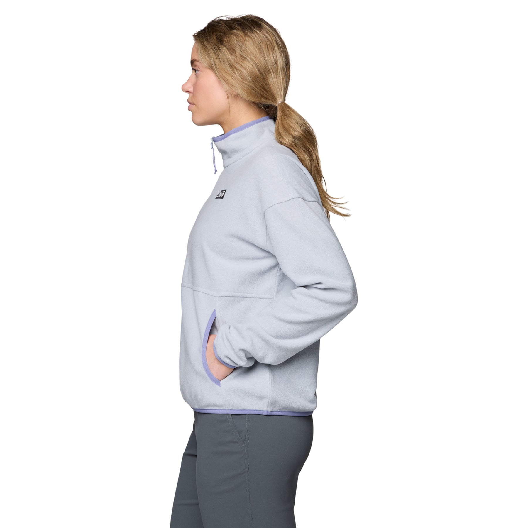 Light gray fleece half-zip pullover shown from side profile with hand in pocket