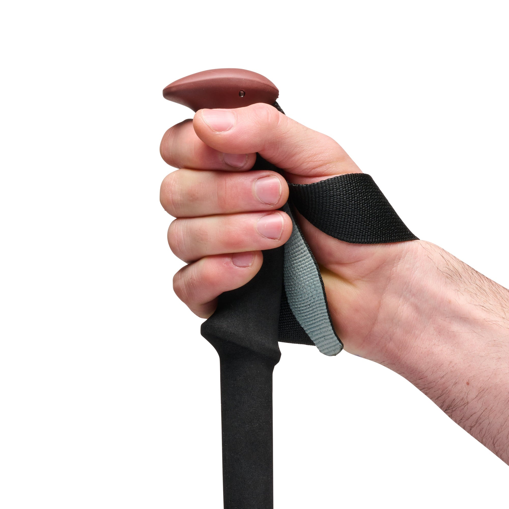 Close-up of hand gripping trekking pole handle with wrist strap, showing ergonomic top grip