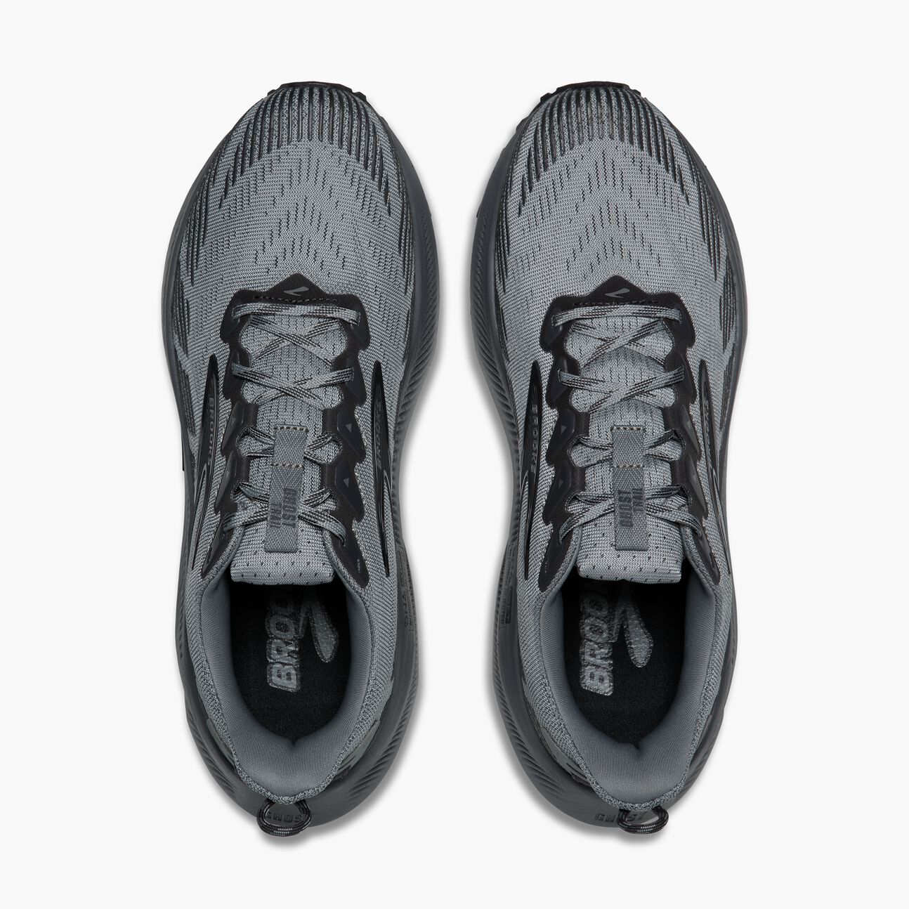 Gray trail running shoes with mesh upper and black lacing, top-down view pair