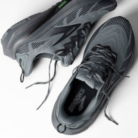Gray trail running shoes with black laces and textured outsole, overhead view