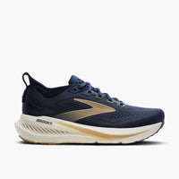 Men's road running shoe in navy blue with gold accents and thick cushioned cream midsole, lateral view