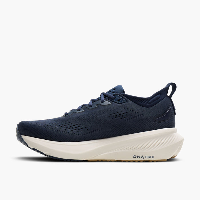 Navy blue men's running shoe with white cushioned midsole, mesh upper, and heel pull tab, side view
