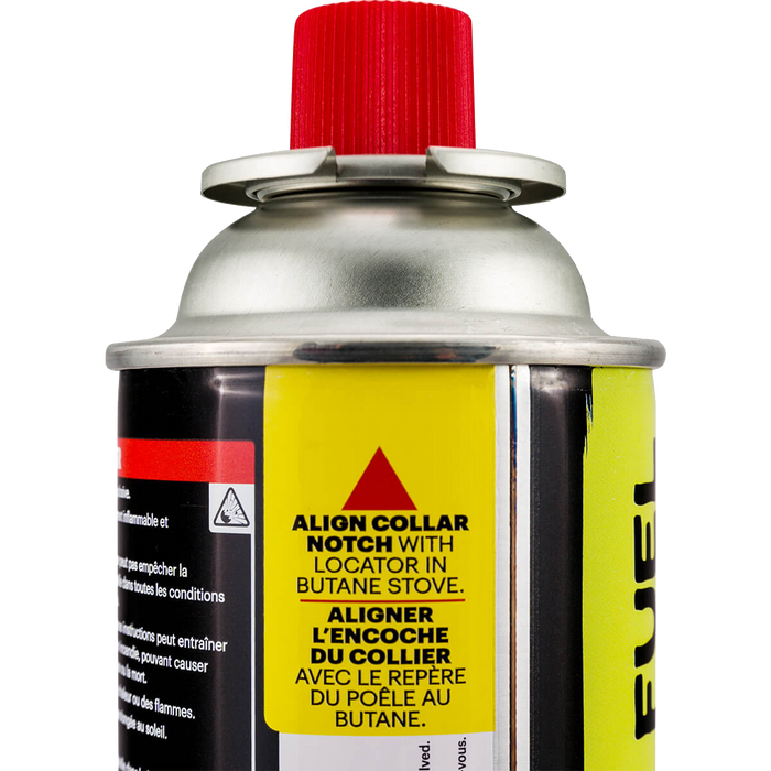 Butane fuel canister with red cap, yellow warning labels and silver valve top