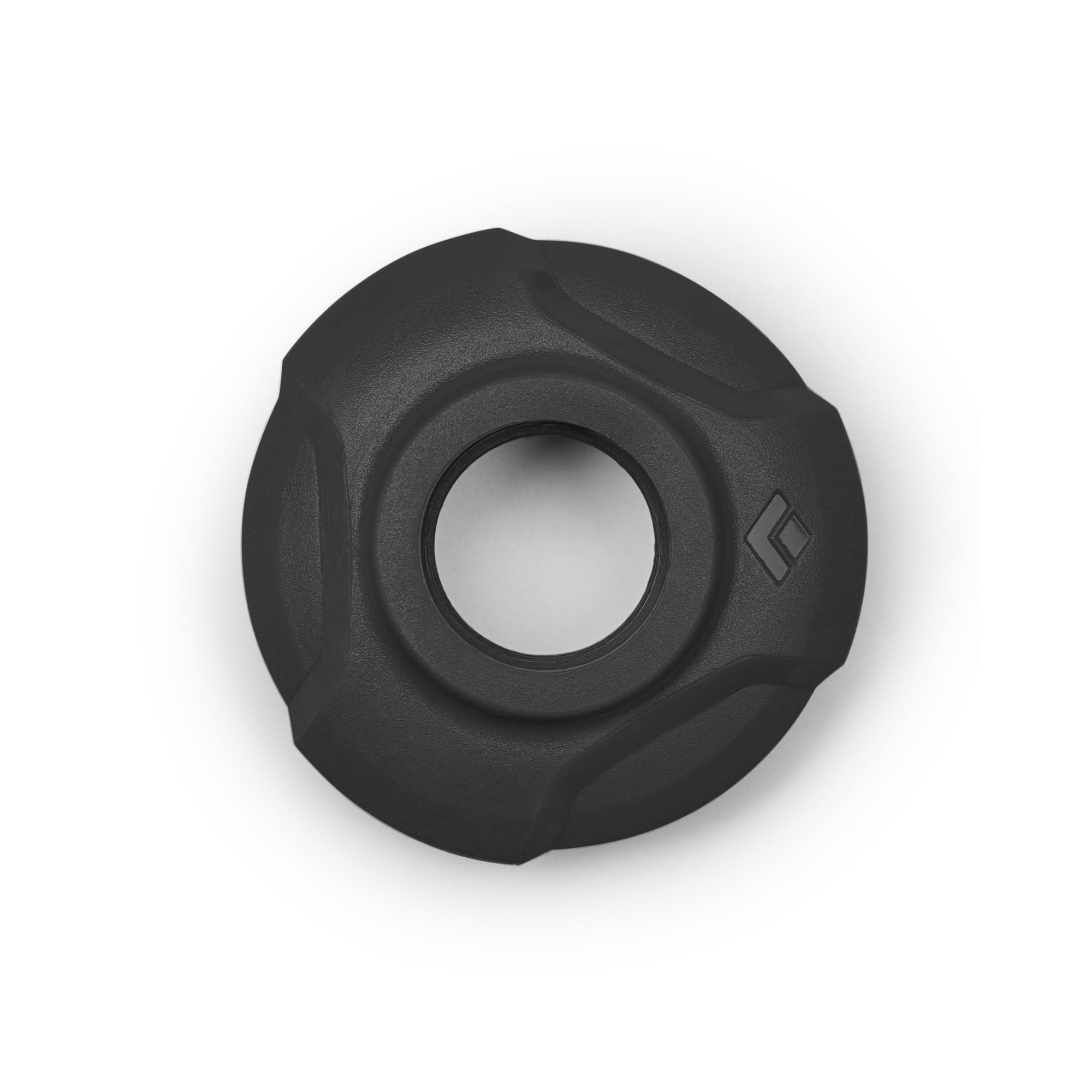Round trekking pole basket with textured grip edges and central hole, top view