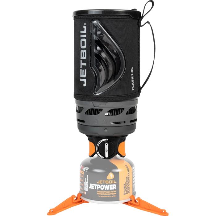 Compact camping stove system with black insulated cup mounted on gas canister with orange stabilizer legs