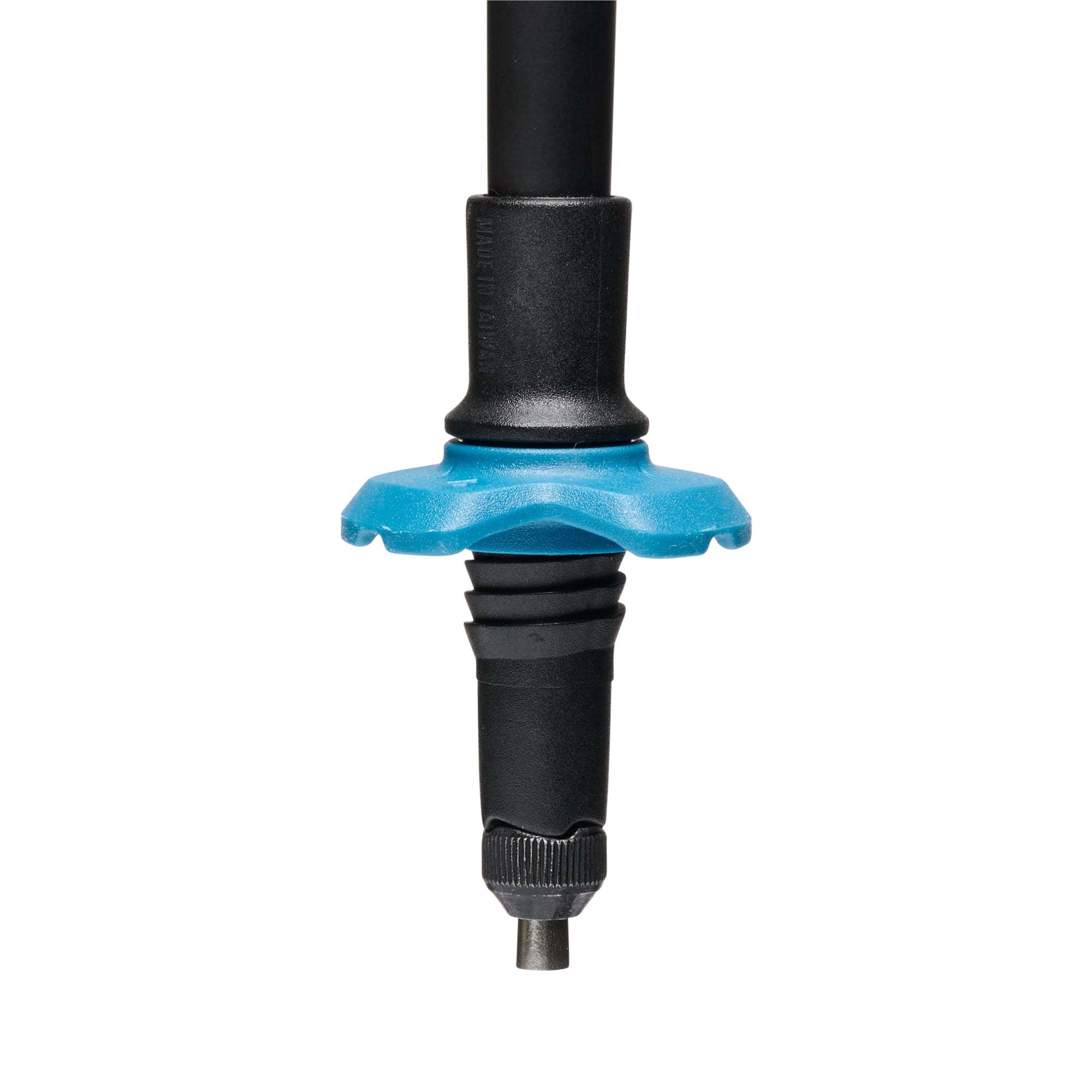 Close-up of trekking pole lower section showing blue star-shaped basket and carbide tip
