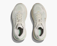 Light colored running shoes with mesh upper, top-down view showing laced design and breathable construction